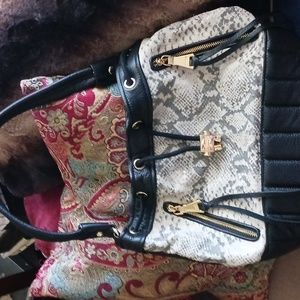 Drawstring leather hobo with snake trim. Double side zips w/tassels